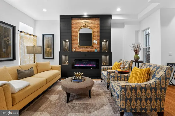 a living room with furniture fireplace and a fireplace