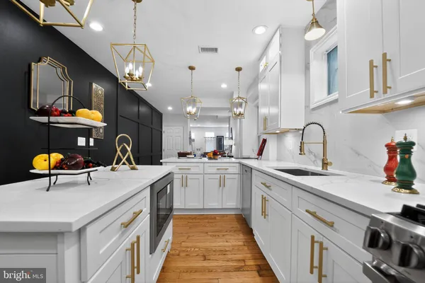 a kitchen with a sink stainless steel appliances and cabinets