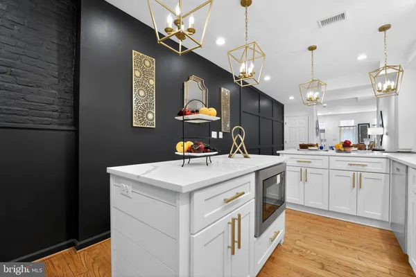 a kitchen that has a sink a stove and oven