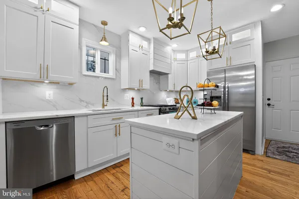 a kitchen with a sink cabinets and wooden floor