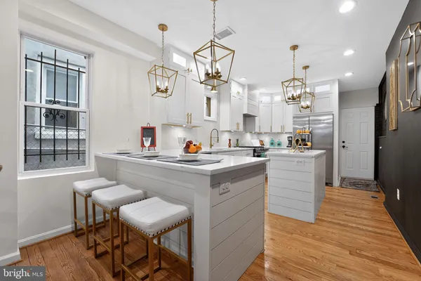a kitchen with a sink cabinets and wooden floor