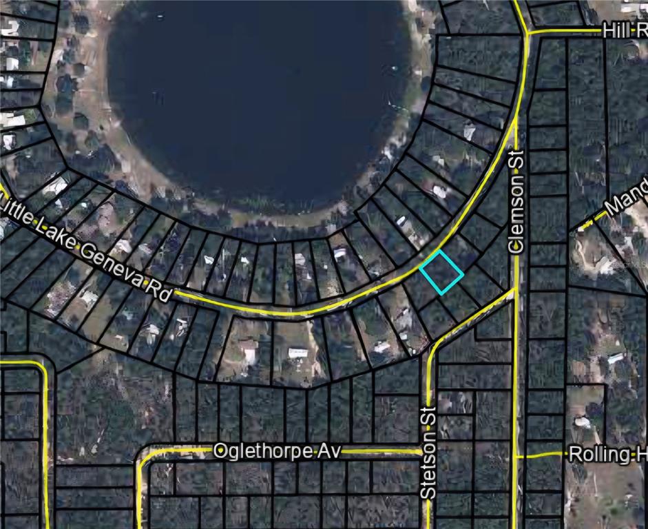 6334 Little Lake Geneva Road Keystone Heights, FL 32656 - Photo 10 of 10 a view of staircase with railing and a chandelier