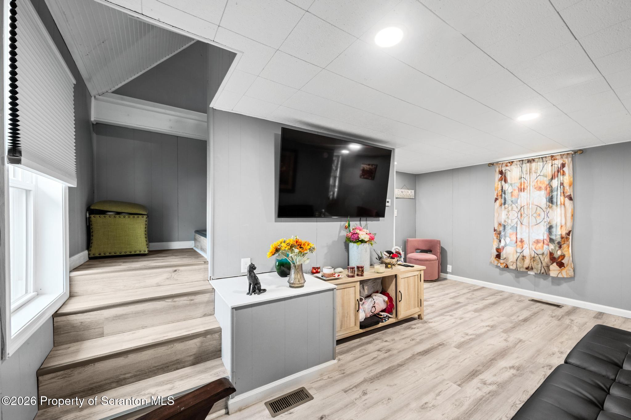 1227 Bennett Street Old Forge, PA 18518 - Photo 12 of 26 a living room with furniture and a flat screen tv