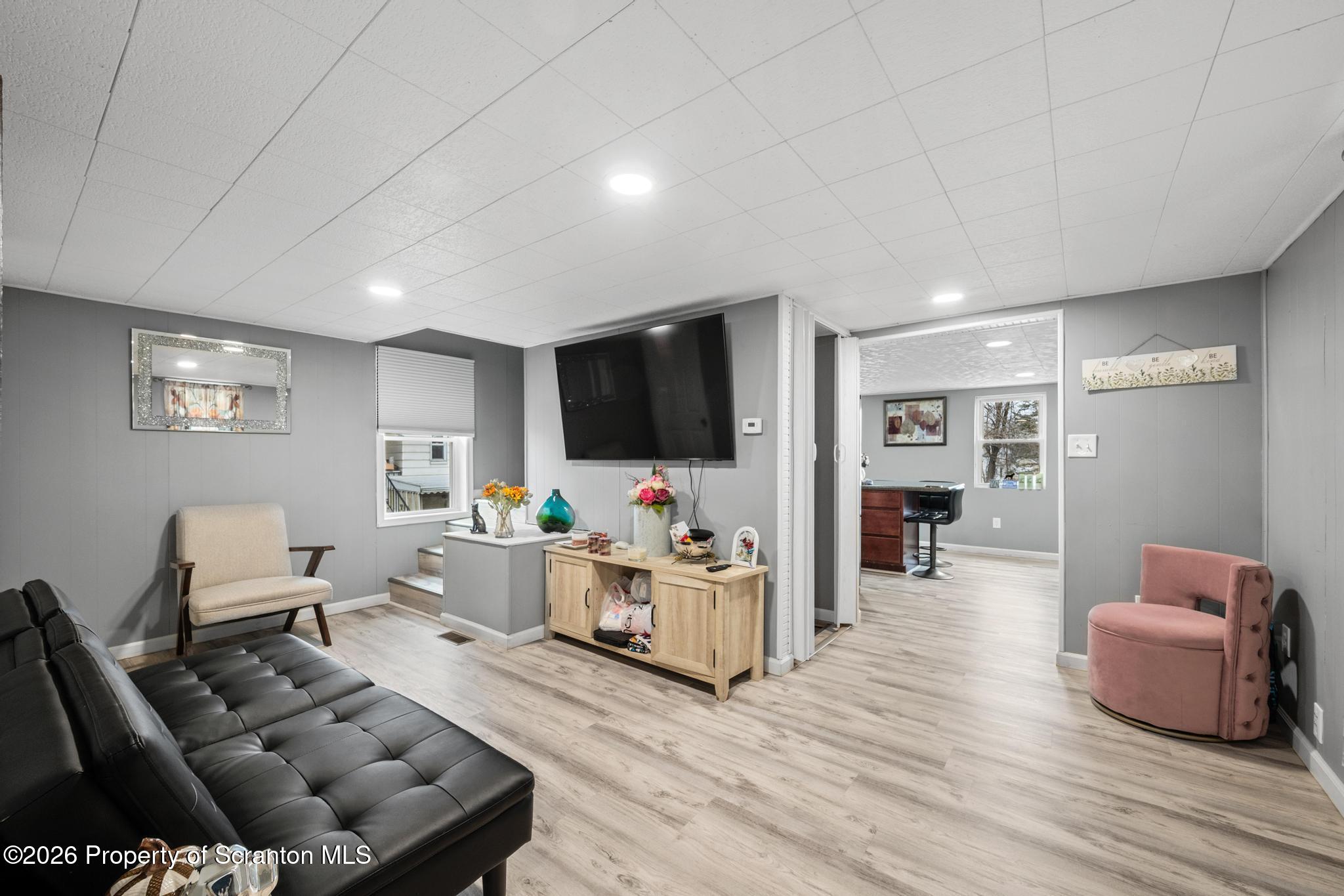 1227 Bennett Street Old Forge, PA 18518 - Photo 13 of 26 a living room with furniture and a flat screen tv
