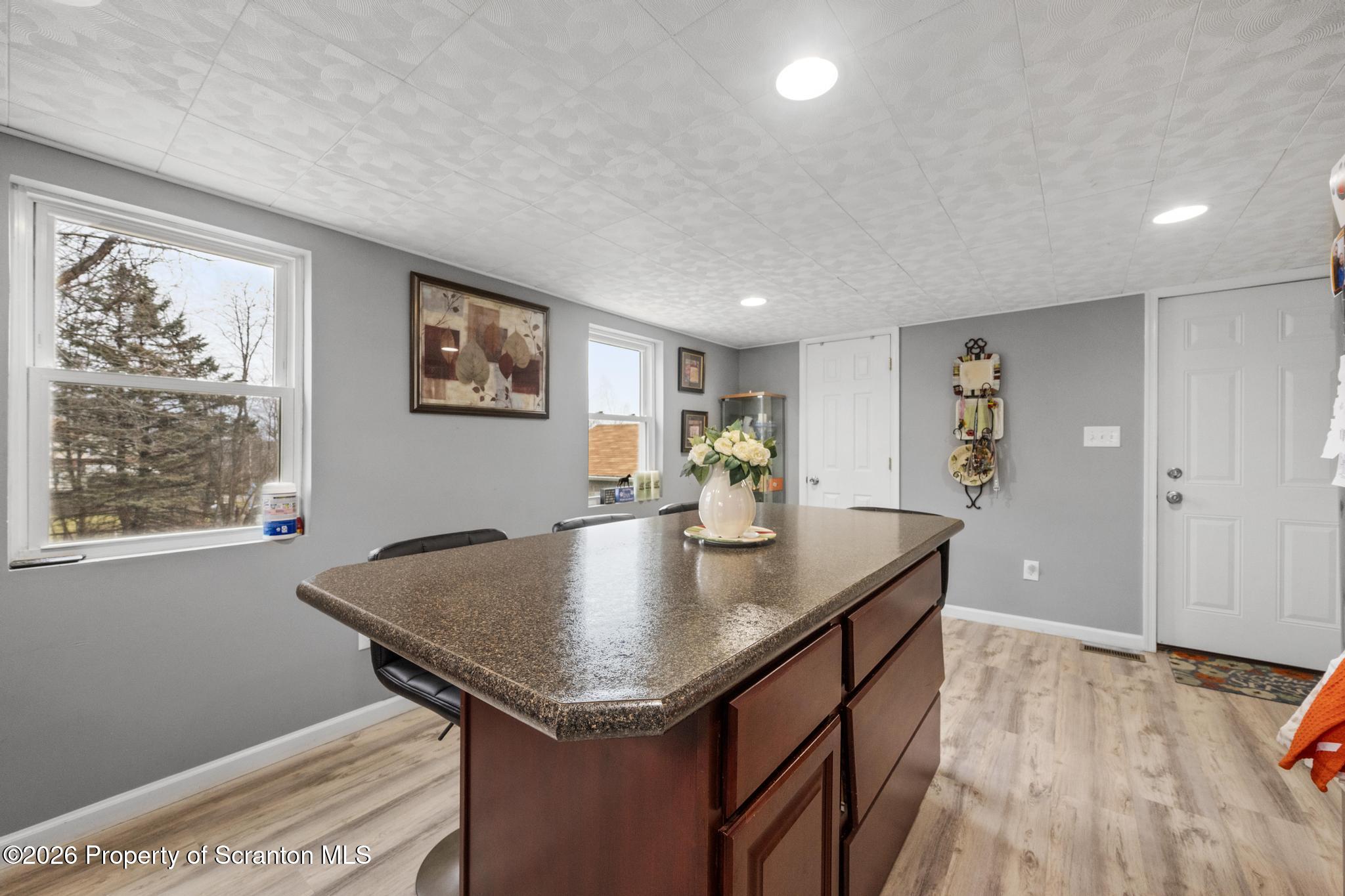 1227 Bennett Street Old Forge, PA 18518 - Photo 10 of 26 a view of kitchen island a sink wooden floor and a living room
