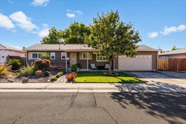 a view of a house with backyard and swimming pool