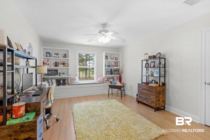 24541 Baldwin Beach Expressway Robertsdale, AL 36567 - Photo 26 of 51 Home office with wood finished floors, baseboards, built in shelves, and ceiling fan