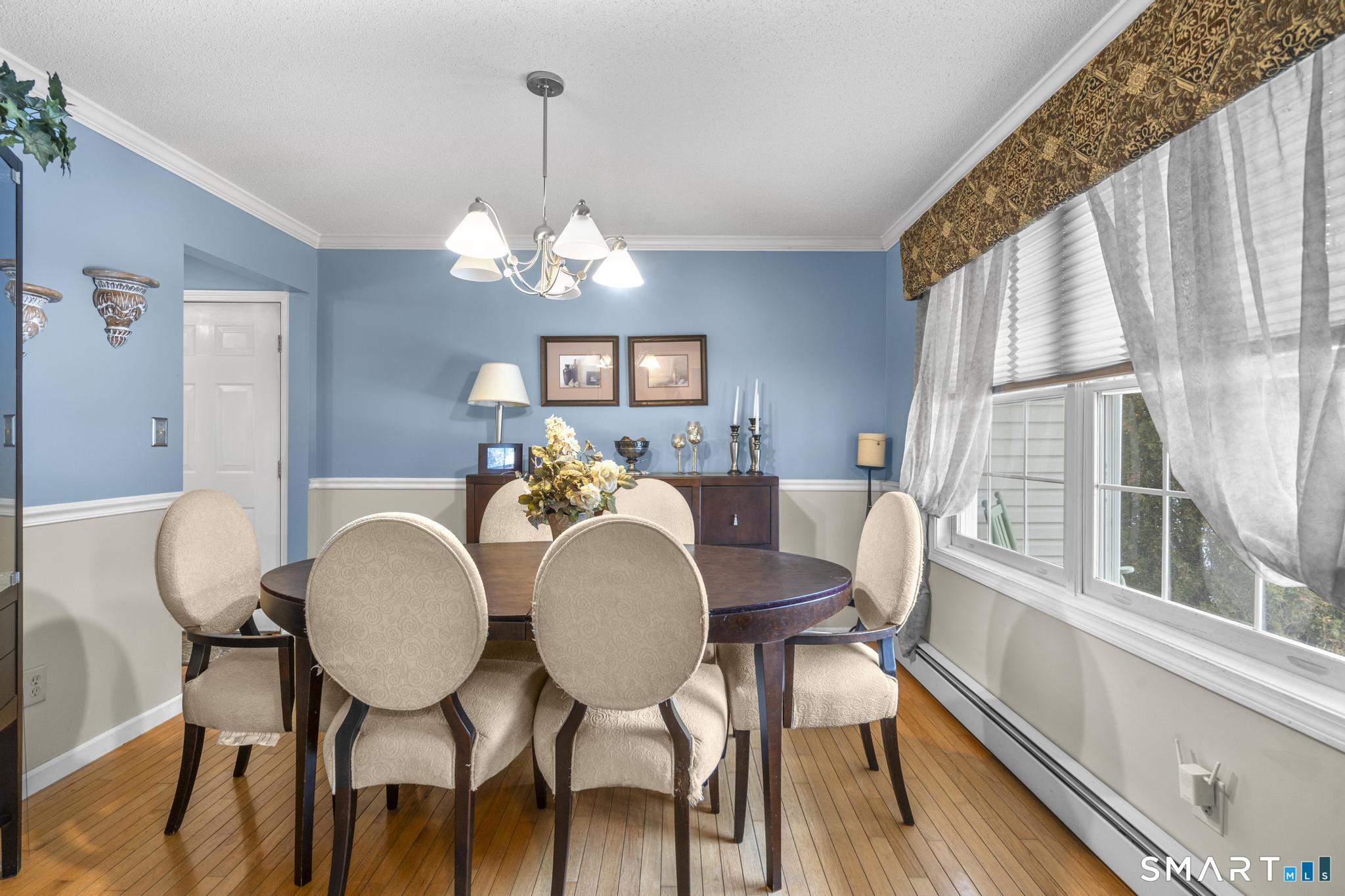 68 Doris Road Bristol, CT 06010 - Photo 16 of 31 a view of a dining room with furniture wooden floor and chandelier