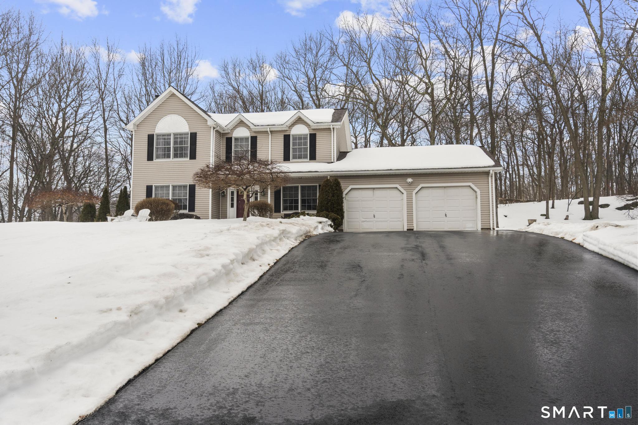 68 Doris Road Bristol, CT 06010 - Photo 2 of 31 a view of a white house with a yard covered in snow