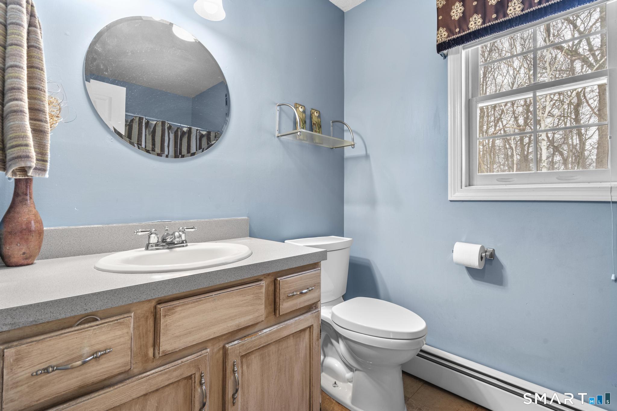 68 Doris Road Bristol, CT 06010 - Photo 21 of 31 a bathroom with a toilet a sink and mirror