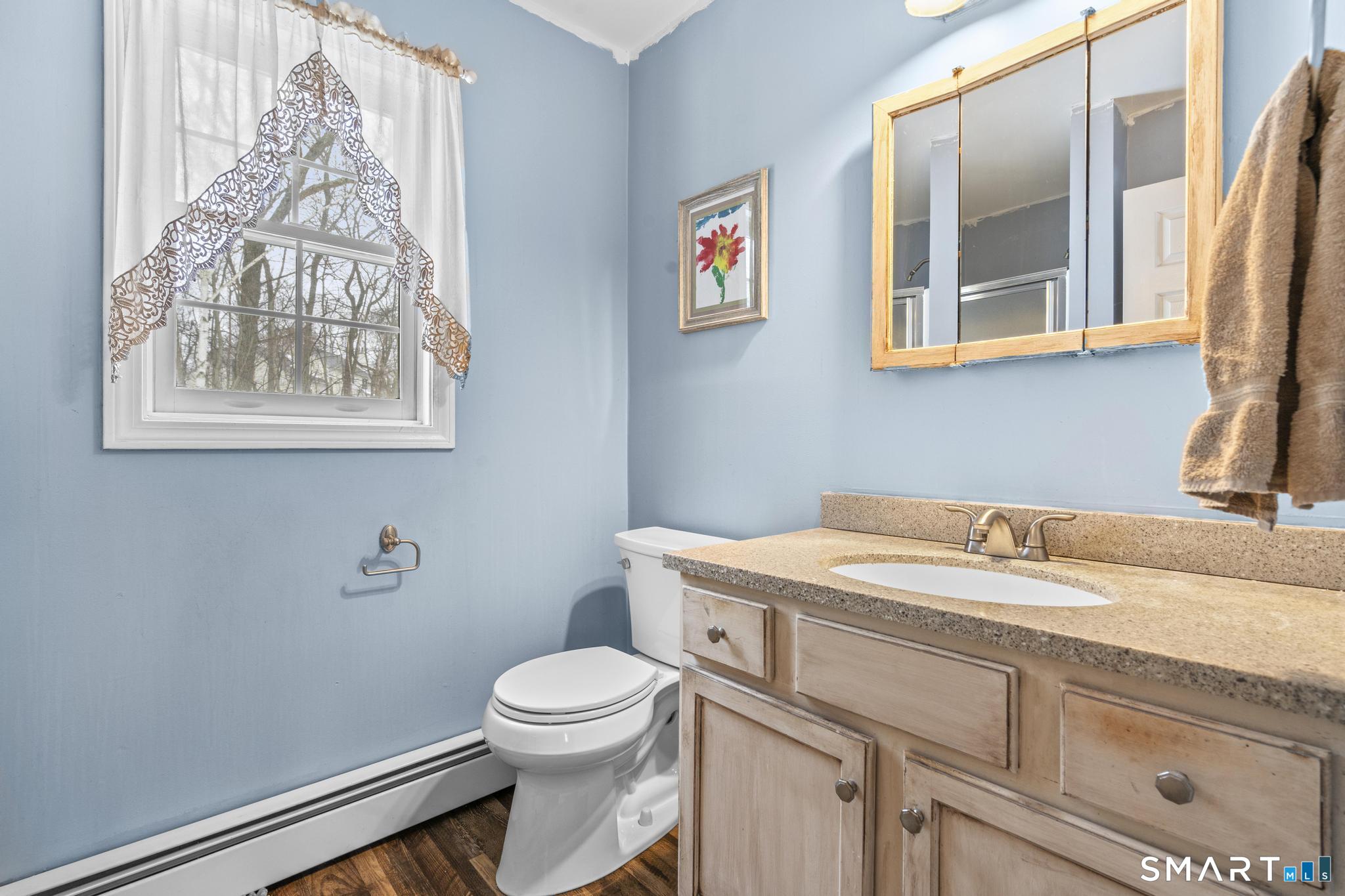 68 Doris Road Bristol, CT 06010 - Photo 24 of 31 a bathroom with a granite countertop sink mirror vanity and toilet