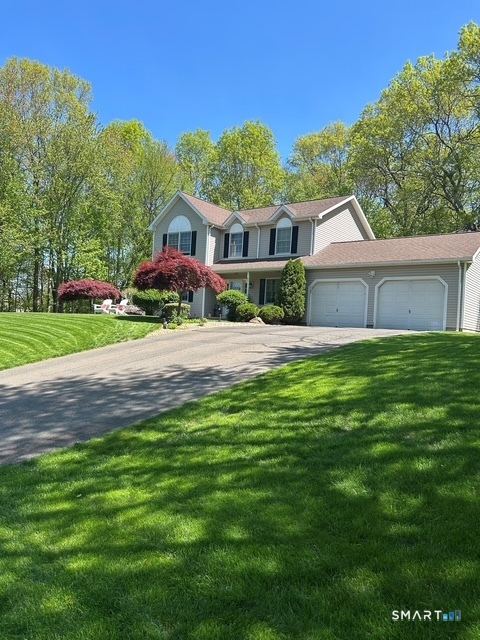 68 Doris Road Bristol, CT 06010 - Photo 29 of 31 a front view of a house with a yard and trees
