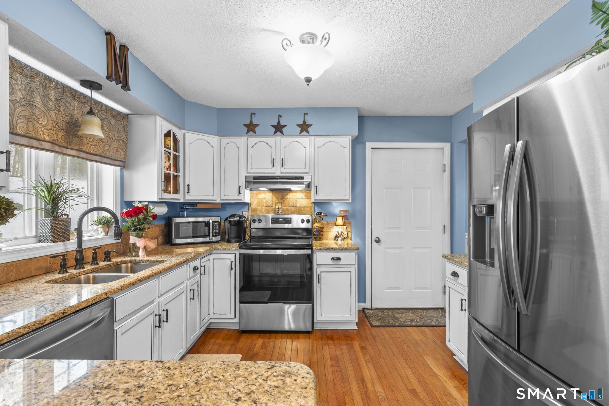 68 Doris Road Bristol, CT 06010 - Photo 4 of 31 a kitchen with stainless steel appliances granite countertop a refrigerator sink and stove
