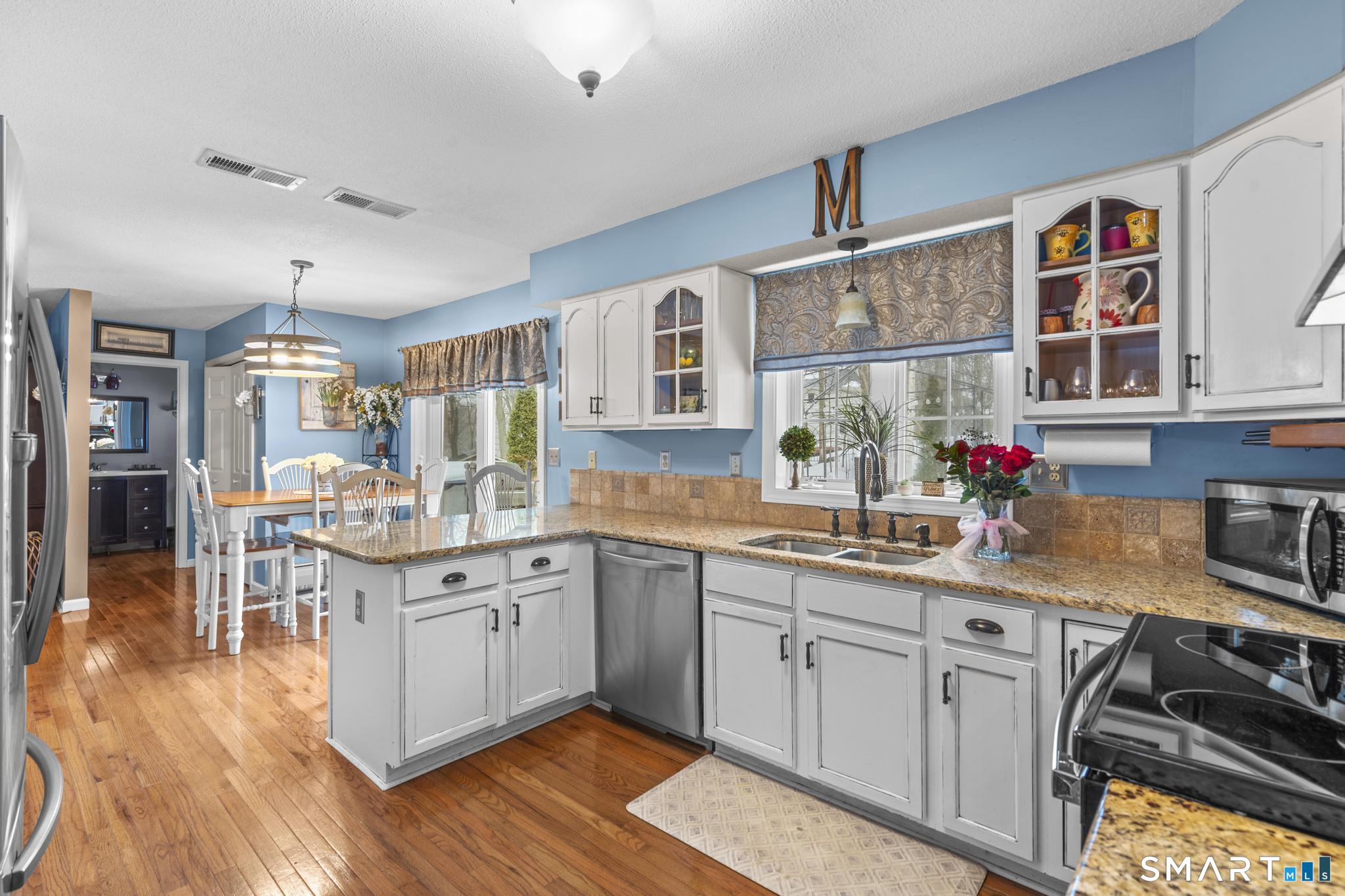 68 Doris Road Bristol, CT 06010 - Photo 6 of 31 a kitchen with stainless steel appliances granite countertop a stove and cabinets