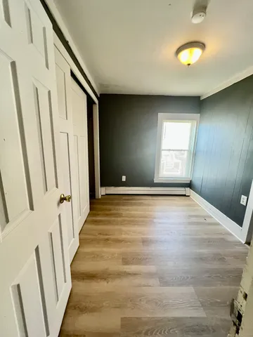 a view of an entryway with wooden floor