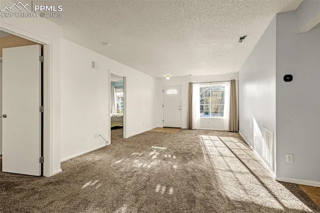 a view of an empty room and window