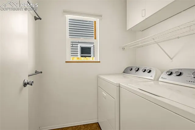 a view of storage and utility room with washer and dryer
