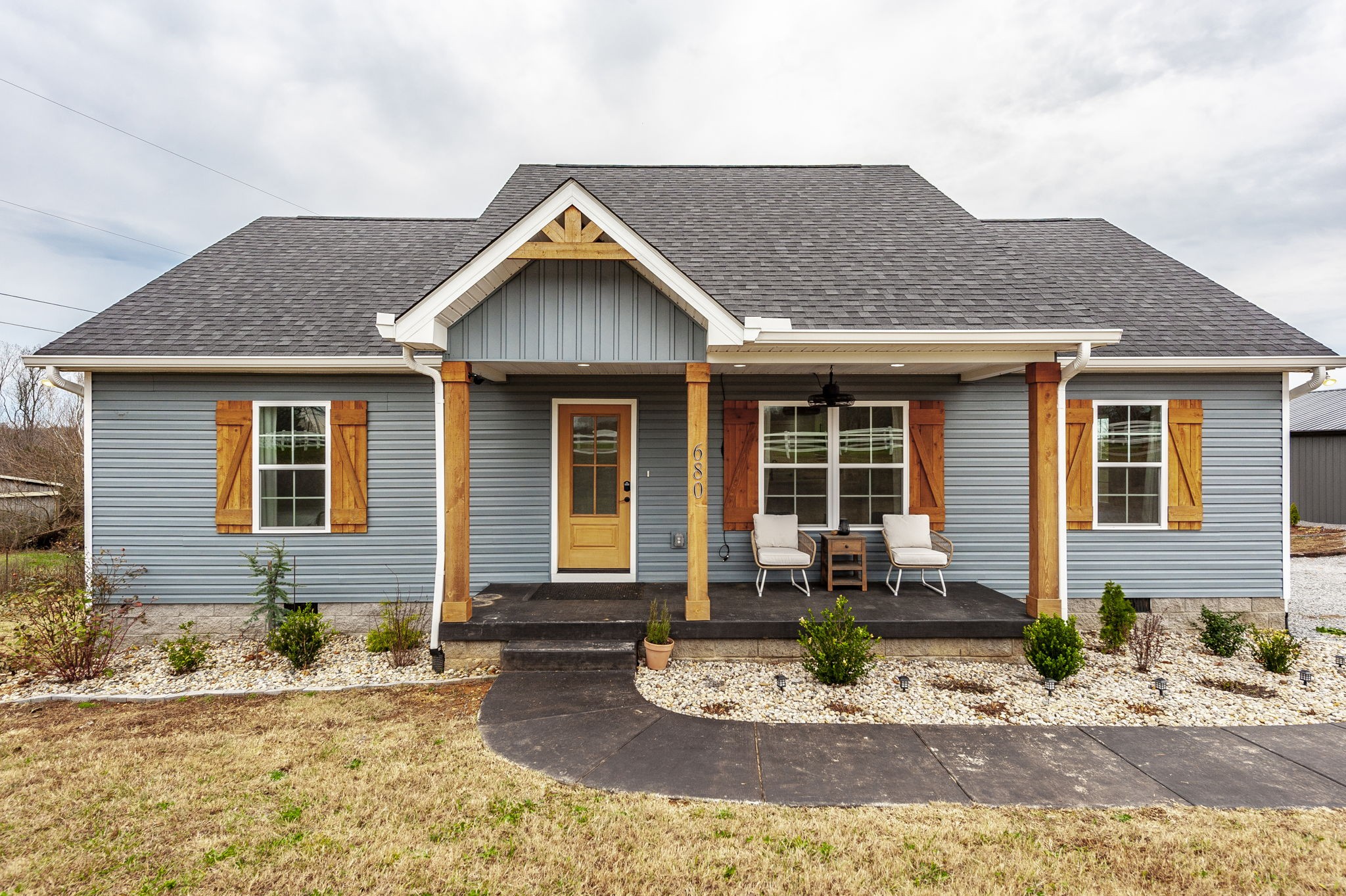 a front view of a house with yard and seating space