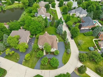 an aerial view of a house with a yard and outdoor seating