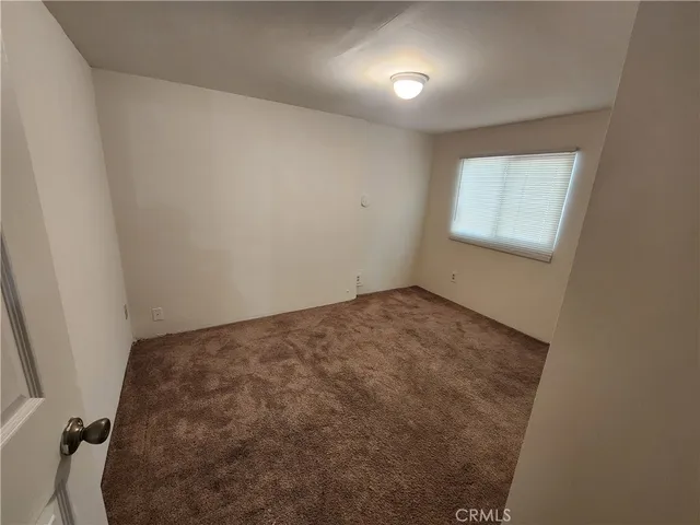 a view of an empty room with windows