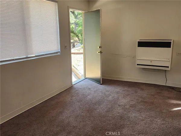 a kitchen with granite countertop a sink cabinets stainless steel appliances and a window