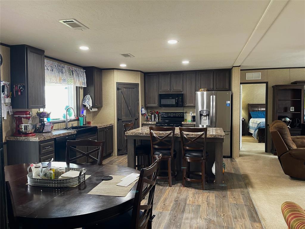 351 Club Lake Road Teague, TX 75860 - Photo 13 of 34 a kitchen with kitchen island granite countertop a sink counter top space and stainless steel appliances