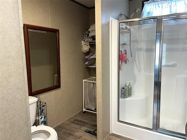 a bathroom that has a glass shower door