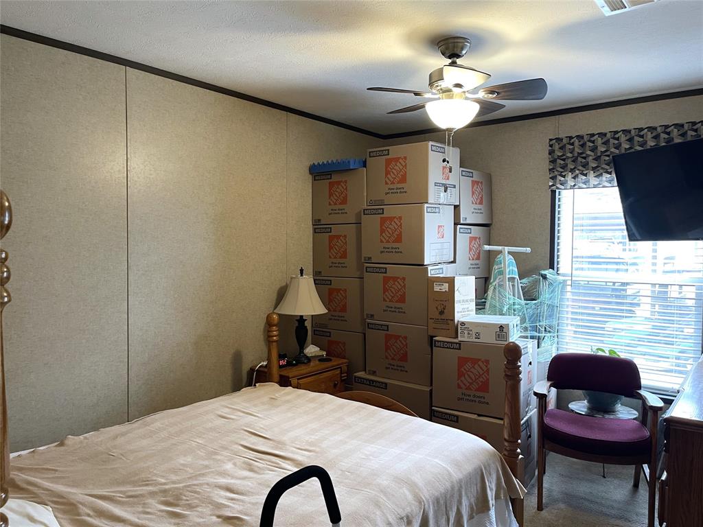 351 Club Lake Road Teague, TX 75860 - Photo 18 of 34 a bedroom with a bed dresser and a flat screen tv