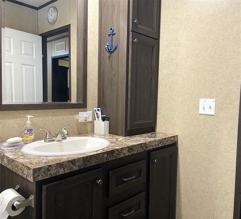 351 Club Lake Road Teague, TX 75860 - Photo 19 of 34 a sink and a mirror