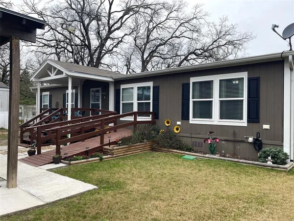 a front view of a house with a yard outdoor seating and barbeque oven