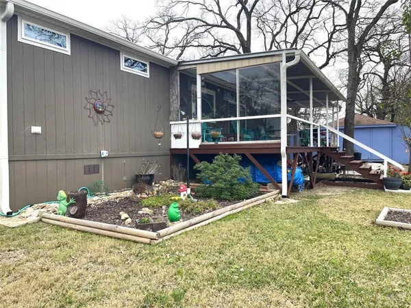 a view of a house with a yard and wooden fence