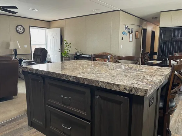 a bathroom with a granite countertop sink a mirror and shower