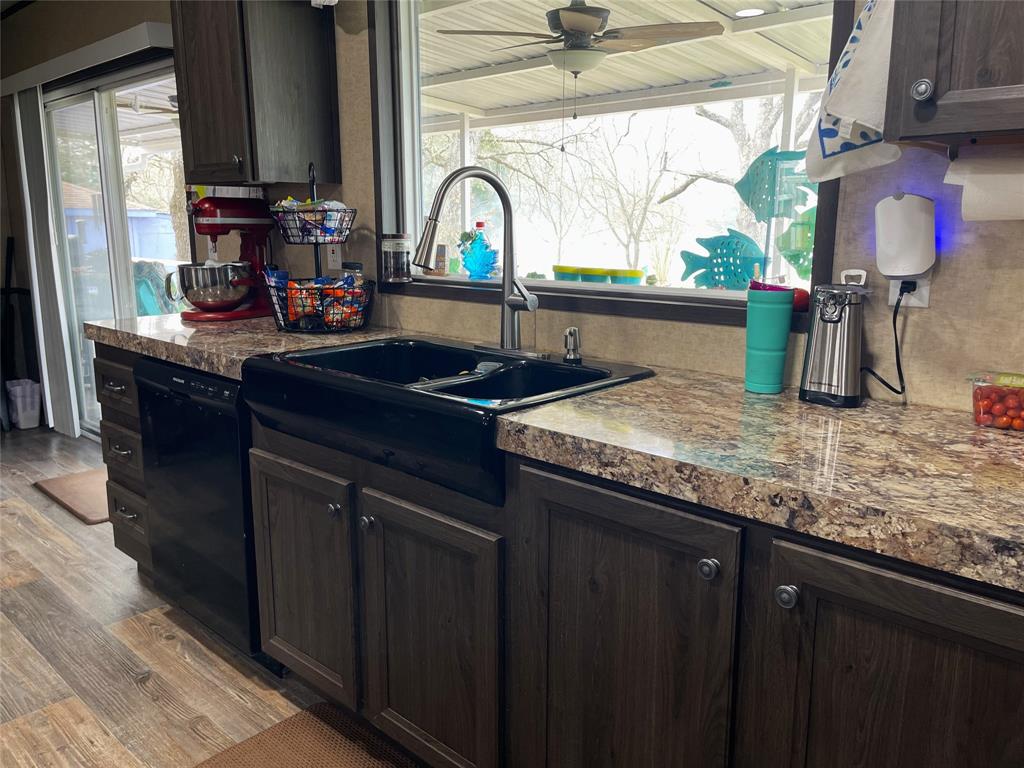 351 Club Lake Road Teague, TX 75860 - Photo 10 of 34 a kitchen with granite countertop sink and cabinets
