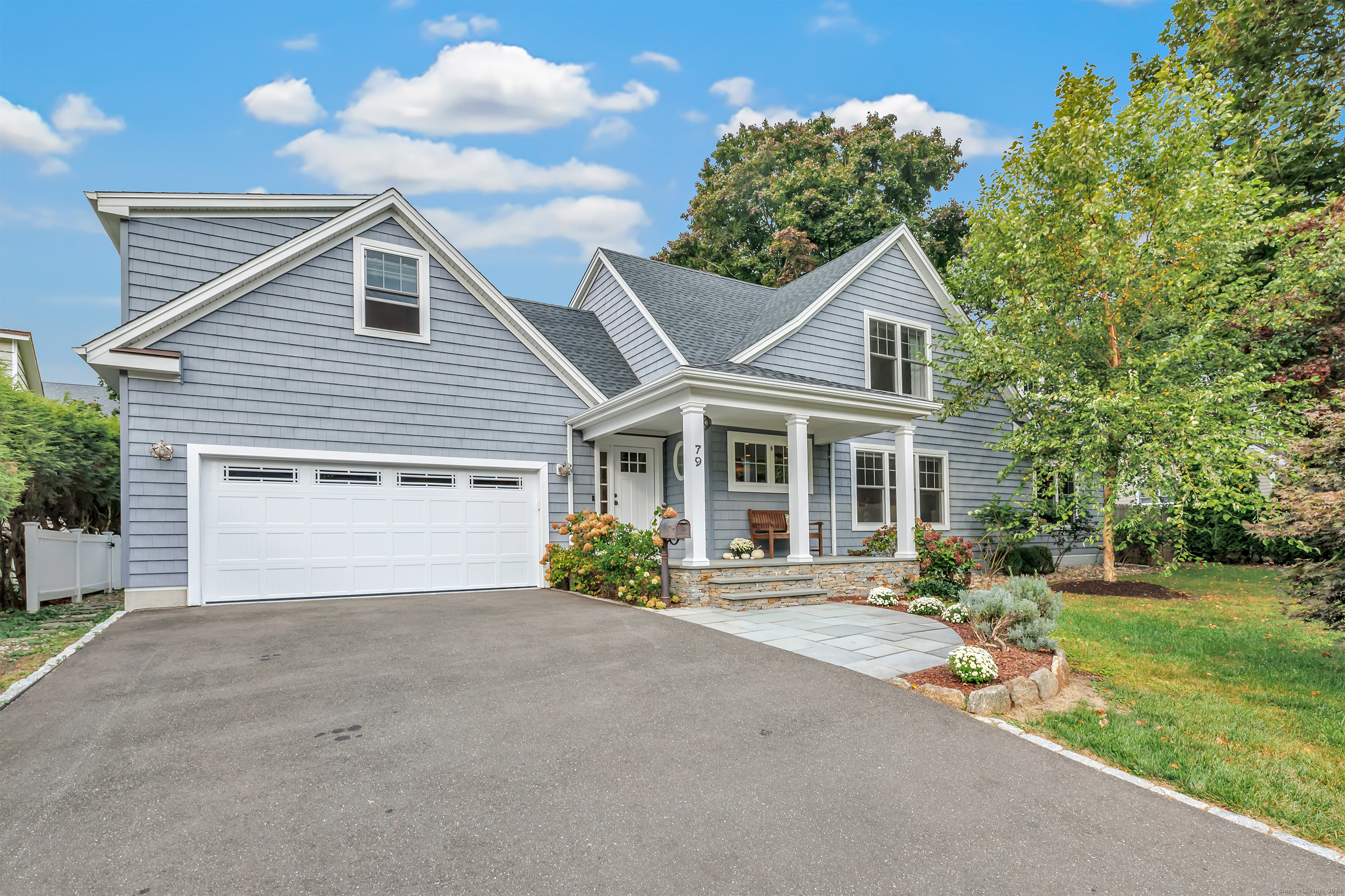 a front view of a house with a yard and a garage