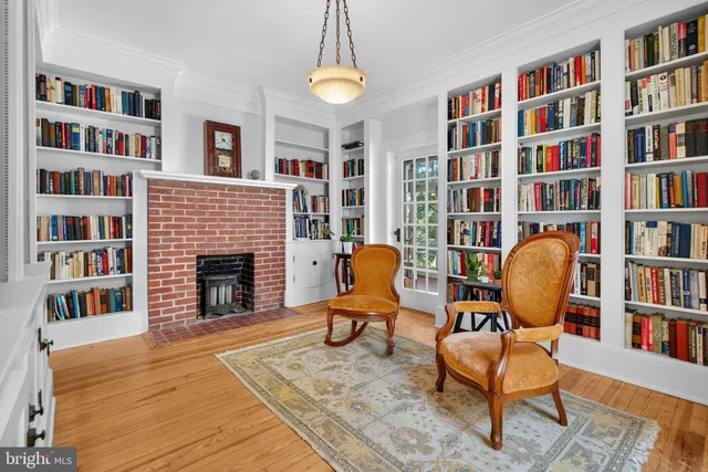 a living room with a bookshelf and a fireplace