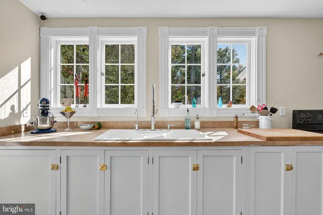 a kitchen with granite countertop a sink and dishwasher with wooden floor