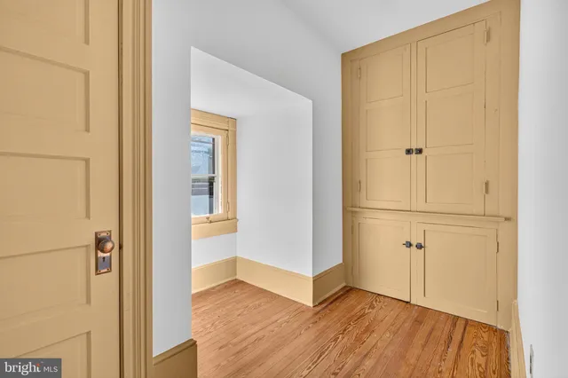 a view of a bedroom with wooden floor and staircase