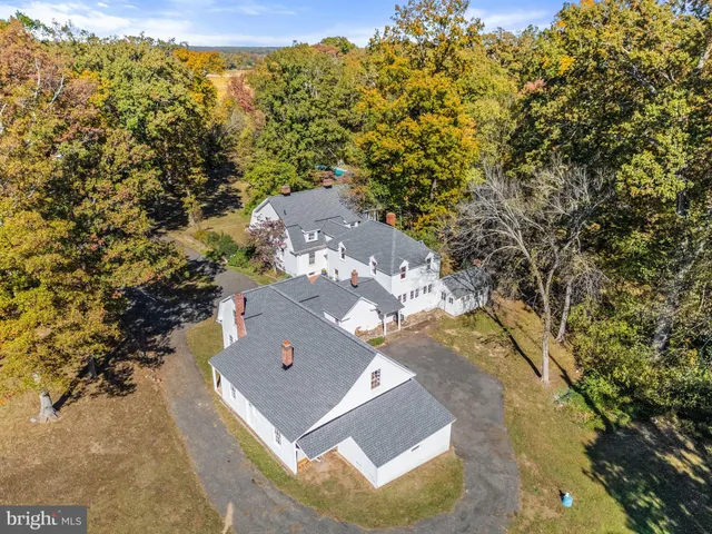 a view of a house with a yard and tree