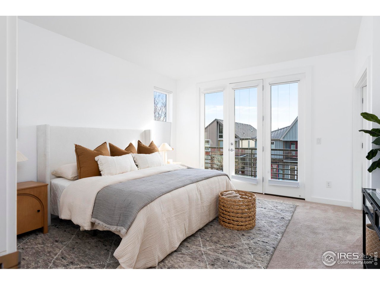 5247 5th Street Boulder, CO 80304 - Photo 13 of 34 a bedroom with a bed a mirror and a night stand