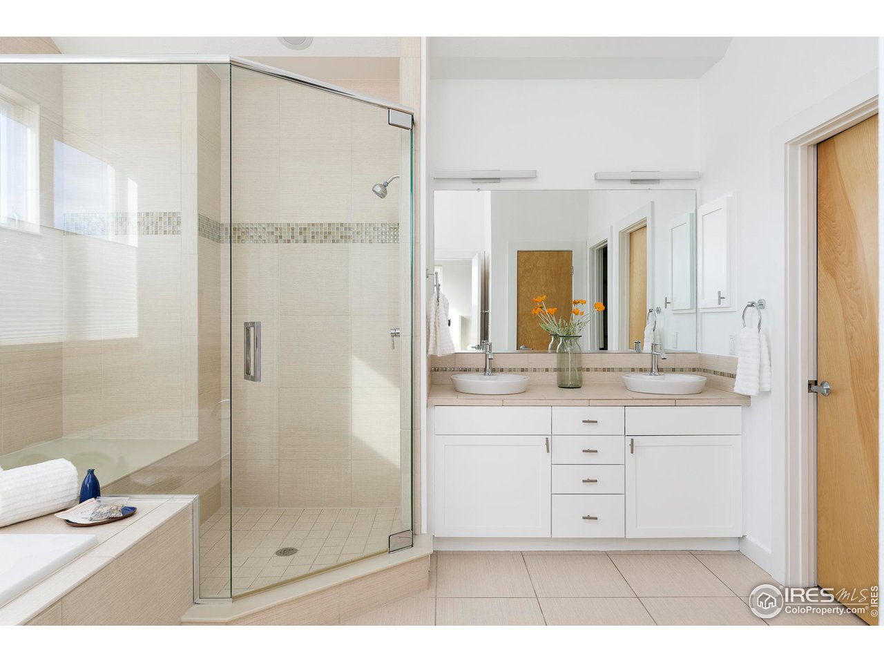 5247 5th Street Boulder, CO 80304 - Photo 15 of 34 a bathroom with a shower sink and mirror