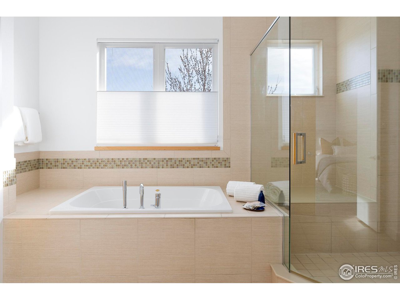 5247 5th Street Boulder, CO 80304 - Photo 16 of 34 a bathroom with a tub a sink and glass door