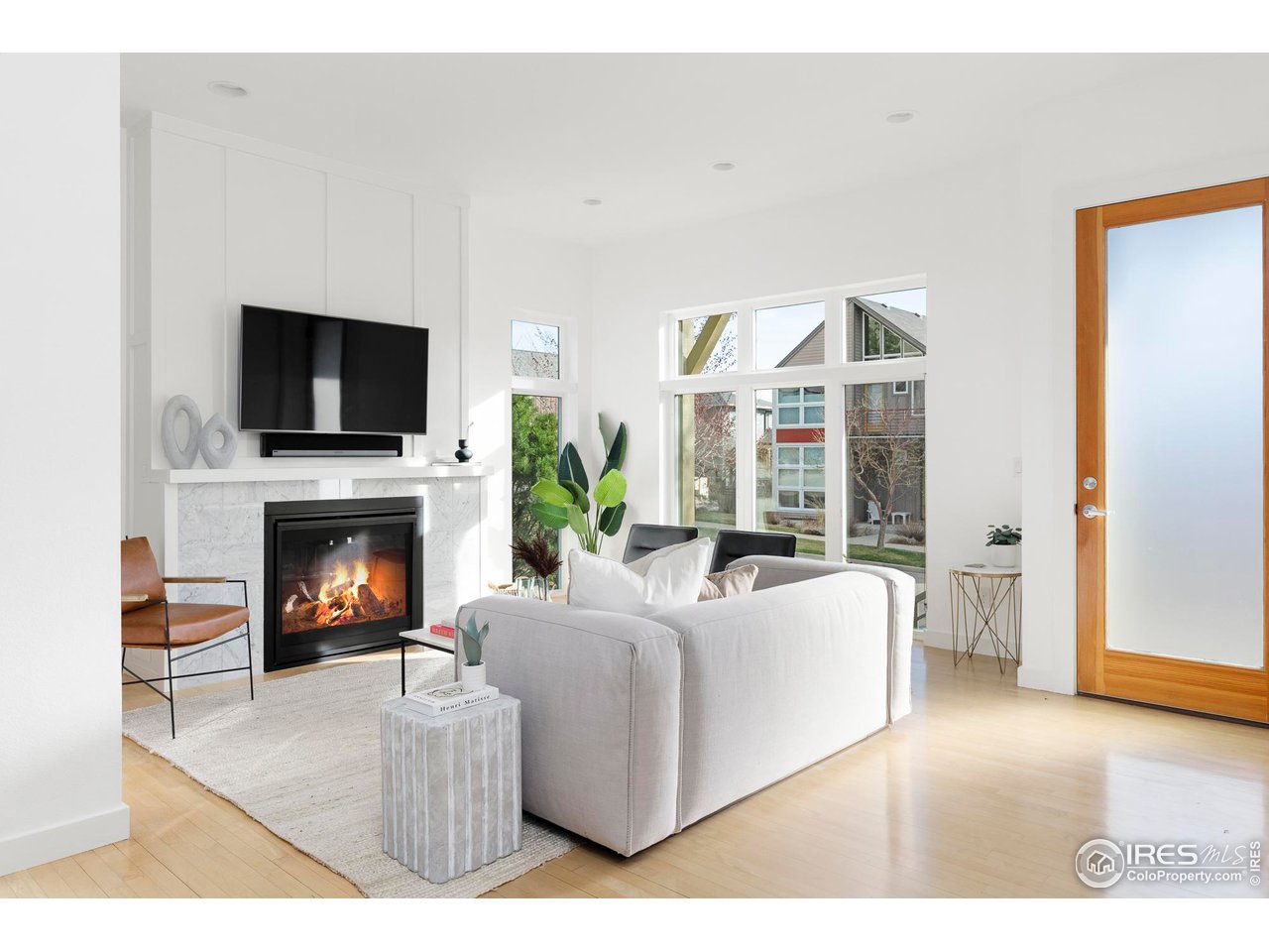 5247 5th Street Boulder, CO 80304 - Photo 3 of 34 a living room with furniture a fireplace and a flat screen tv