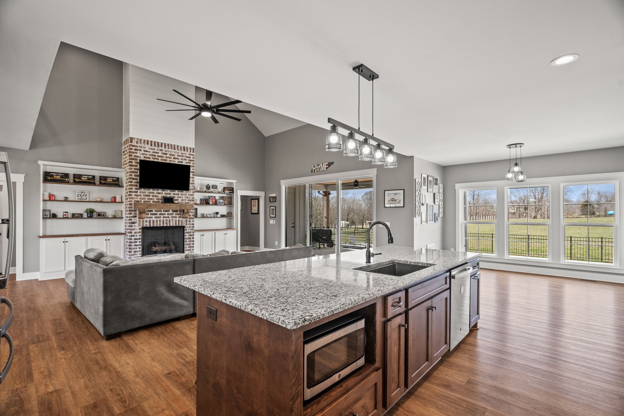 1155 Maxwell Branch Road Cottontown, TN 37048 - Photo 30 of 69 a open kitchen with stainless steel appliances granite countertop a stove and a wooden floors