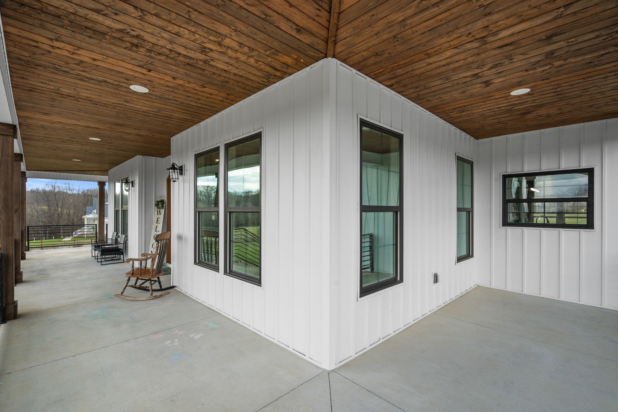1155 Maxwell Branch Road Cottontown, TN 37048 - Photo 60 of 69 a view of a porch with two chairs and a large window