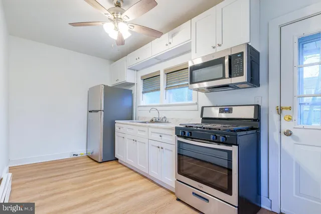 a kitchen with stainless steel appliances granite countertop a stove microwave and refrigerator