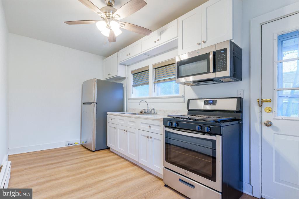 148 East Holly Avenue Pitman, NJ 08071 - Photo 3 of 11 a kitchen with stainless steel appliances granite countertop a stove microwave and refrigerator