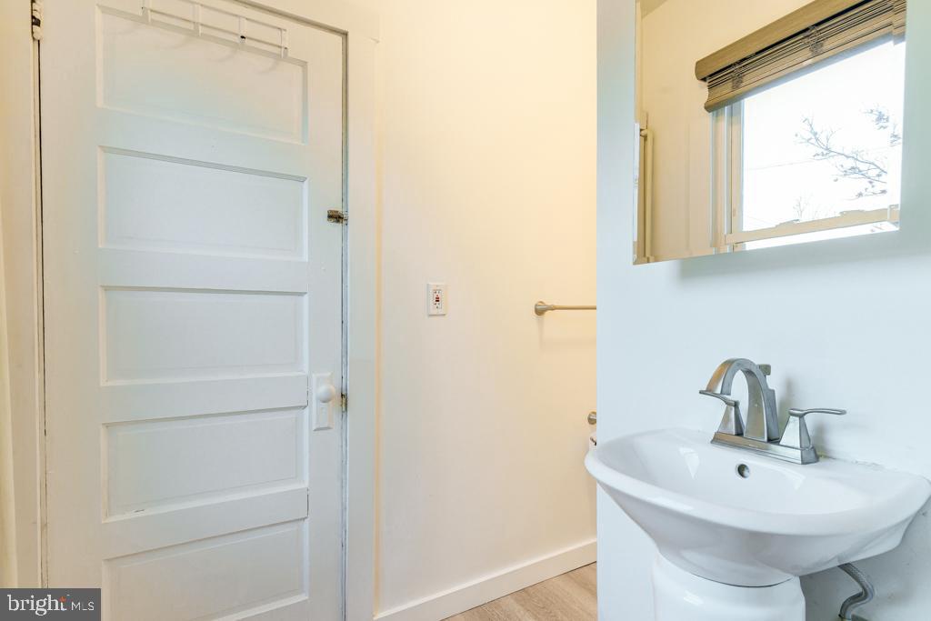 148 East Holly Avenue Pitman, NJ 08071 - Photo 4 of 11 a bathroom with a sink and a mirror