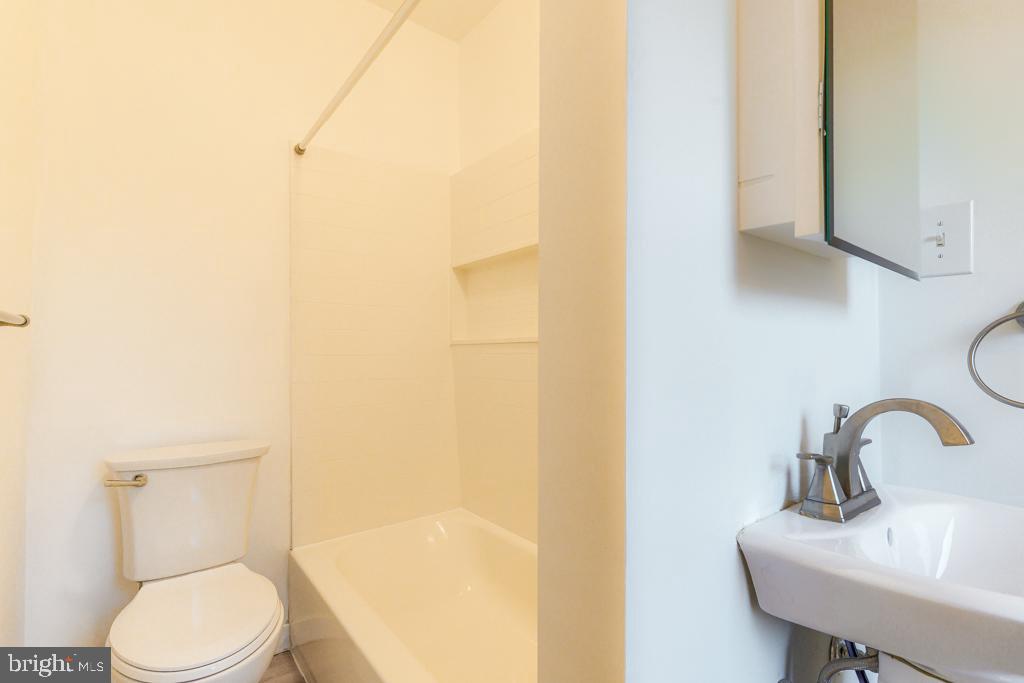 148 East Holly Avenue Pitman, NJ 08071 - Photo 5 of 11 a white toilet sitting next to a bathroom sink