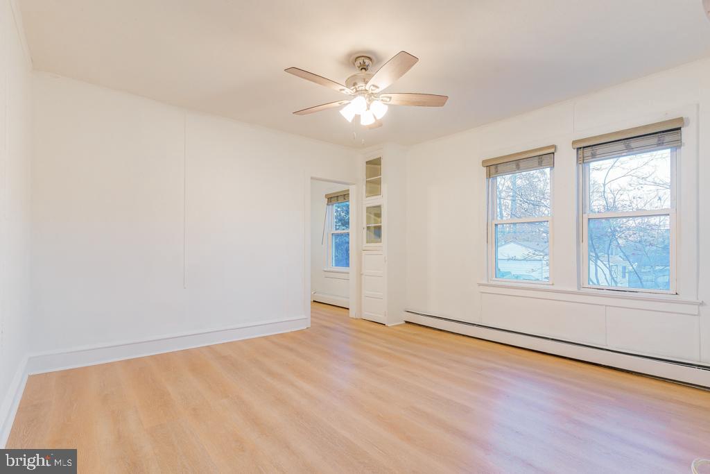 148 East Holly Avenue Pitman, NJ 08071 - Photo 6 of 11 a view of an empty room with wooden floor and a window