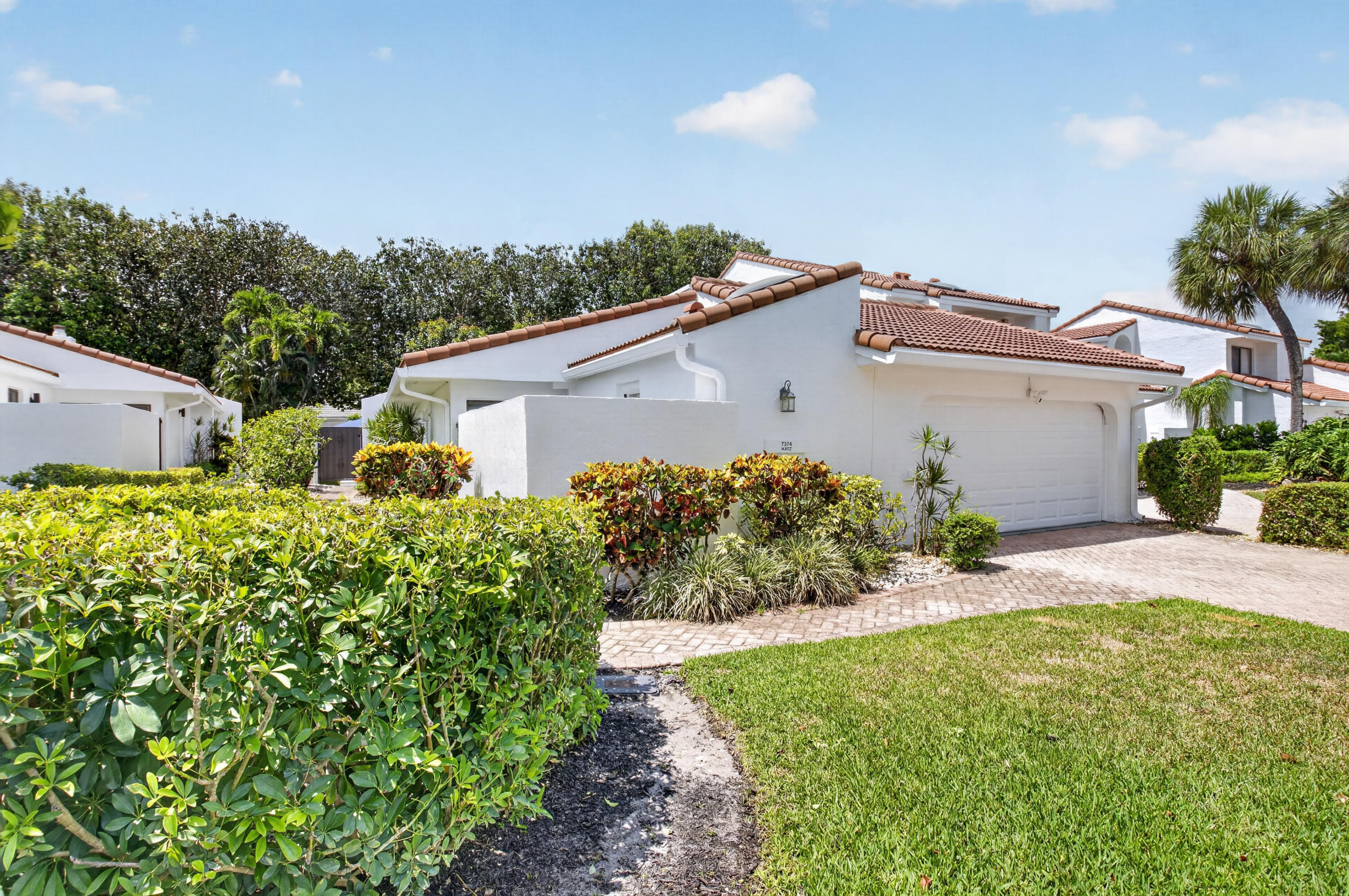 7374 Woodmont Court Boca Raton, FL 33434 - Photo 45 of 95 a view of a house with a yard and plants
